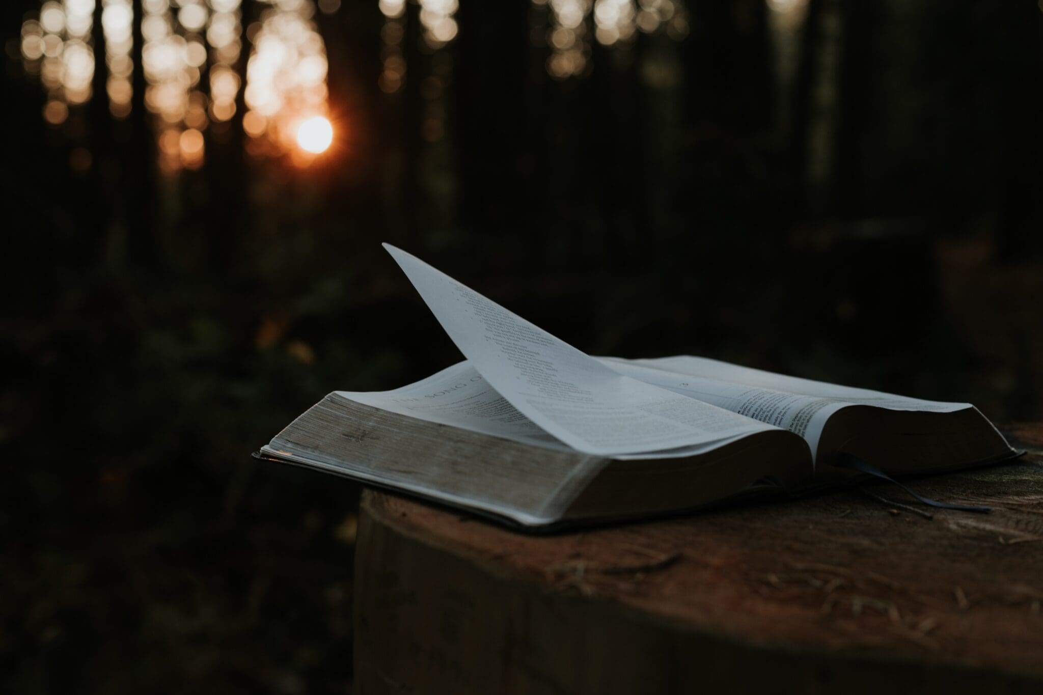 An open bible laying on a table