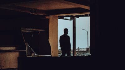 Person standing in window with mystery