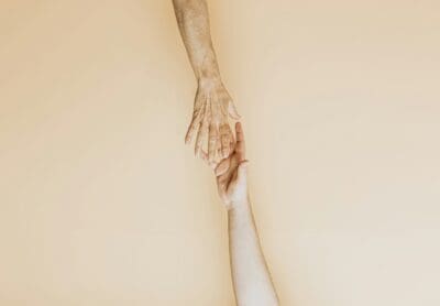 Hands Touching Yellow Background