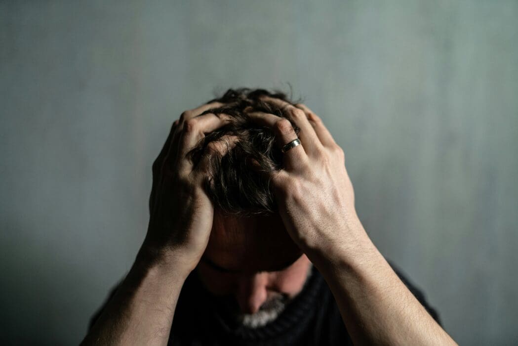 Man Holding Head Despair Pain Confusion