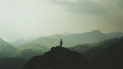 Person Standing on Mountain