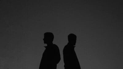 Two silhouetted profiles resembling father and son, echoing Adam and Seth's shared likeness.